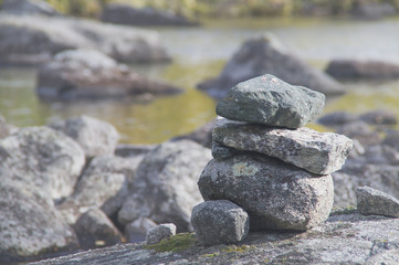 Cairn on the shore of a mountain lake.