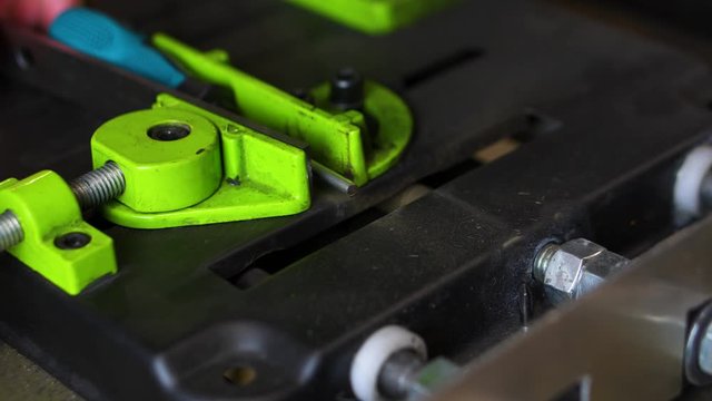 Angle grinder machine cuts tip off of screwdriver front top view sparks fly