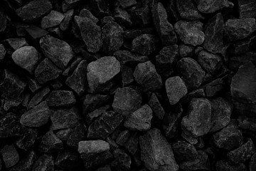 Natural fire ashes with dark grey black coals texture. It is a flammable black hard rock. Space for text.