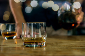 glass of whiskey and ice on table