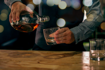 bartender pouring drink in a bar