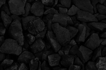 Natural fire ashes with dark grey black coals texture. It is a flammable black hard rock. Space for text.