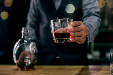 man holding glass of wine at restaurant