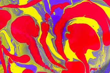 Red swirls on yellow and violet waves. Abstract background or texture. Acrylic Fluid Art