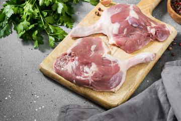 Raw duck meat on a chopping Board on a gray table. Top view. Place for text
