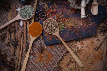 Spicy condiment, herbal aroma dry food for Asian cookin on wood  cutter with dry seed and colorful powder for kitchen ingredient