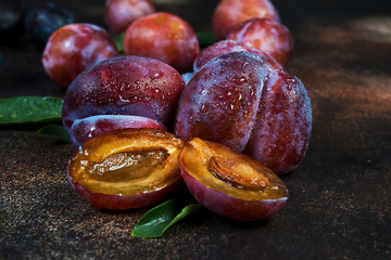 Fresh ripe plums. Plum ugly trend on a concrete background.