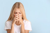 Stressed young woman on color background