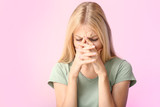 Stressed young woman on color background