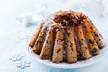 Traditional Christmas fruit cake, pudding on white plate. Copy space.