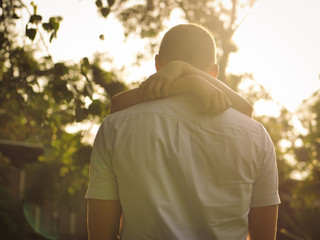 Romantic couple holidng together with sun light in evening.