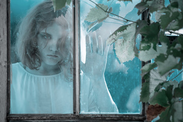 girl ghost in the old window