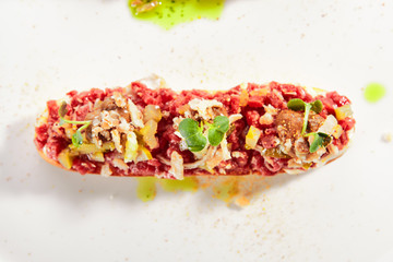Beef Tartare on Toast with Black Garlic Cream Isolated