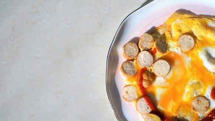 fried eggs and sausages with tomato sauce