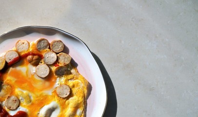 fried sausages and eggs at plate