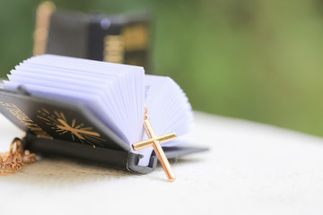 Gold Christ cross lace with holy bible, black cover. European religion conceptual for Christian faith, pray and hope