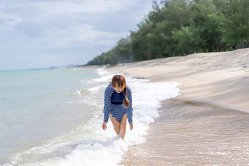 Happy woman is Enjoying and running  Summer Vacation on the beach