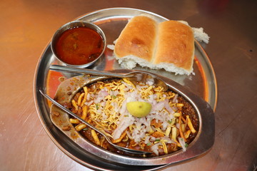 Close up view of indian  street food in Mumbai. Maharastra fast food- missal pav. - obrazy, fototapety, plakaty