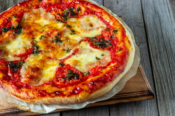 Italian pizza with tomatoes and mozzarella cheese. Italian cuisine. Margherita.