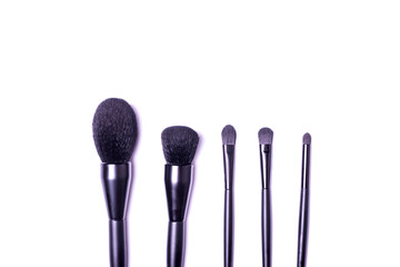 Professional make-up brushes isolated on white background top view.