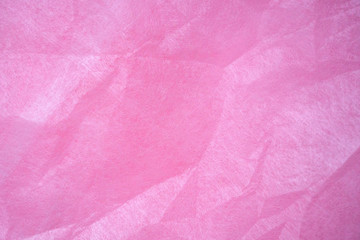 Obraz premium Pink crumpled wrapping paper background and texture. Tender pink background creates a romantic mood