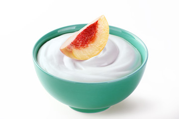 cream sour in a plate with peach isolated white backround