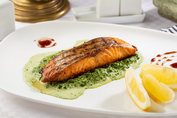 Red fish and spinach sauce, food close-up