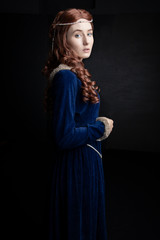 Medieval woman in blue velvet dress