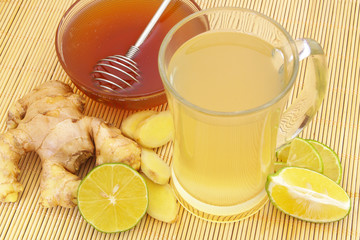 Cup of fresh ginger tea with lime and honey 