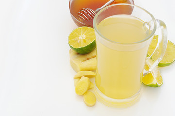 Ginger tea cup, lime and honey on table with space for text