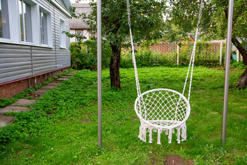    Braided rope swing weigh on the bar in the country.Horizontally.