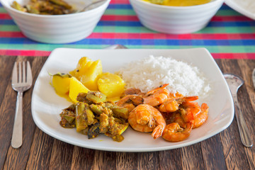     Shrimp dish with rice and vegetables on a plate.Horizontally.