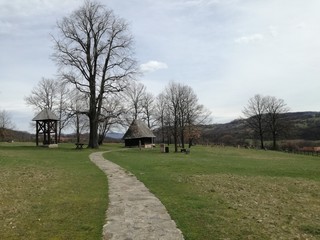 An old rural wooden church at the end of a stone path