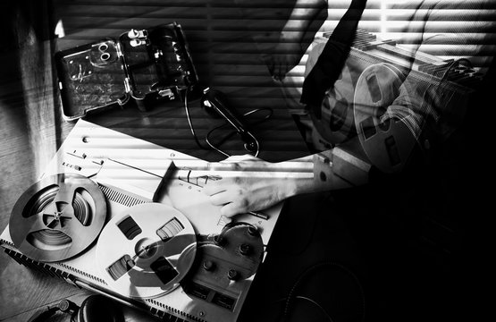 Special agent speaks on field telephone set USSR. Officer wiretapping   on the reel tape recorder. KGB spying conversations. Black and white photo.