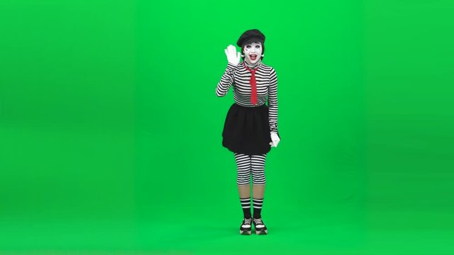 Mime girl calling someone, smiling, gesticulating. Chroma key. Full length.