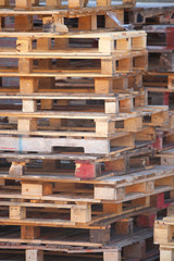 closeup of pile of empty wooden pallets
