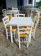 Tables and chairs in a coffee shop in the street
