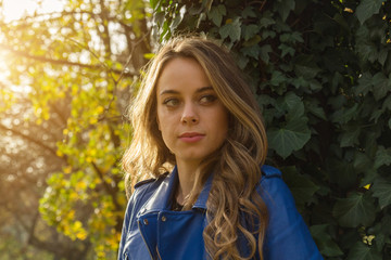 Young woman posing in nature at autumn / fall time.