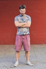Young man posing in front of a camera.