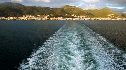 Trail on water from boat floating in Mediterranean sea. Greece. 4K