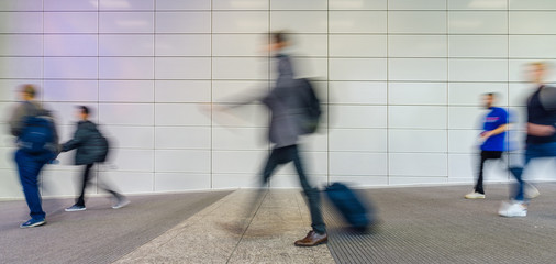 Many people go through the bright corridor of a business trade fair 