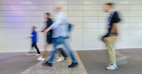 Many anonymous business people go to a business trade fair