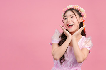 Beautiful women dressed in beautiful pink princess dresses are standing on a pink background.