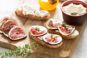 ciabatta or bruschetta with cottage cheese, figs and honey. sandwich with figs and goat cheese