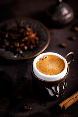 Coffee cup and beans on old kitchen table. turkish coffee and turkish delight with copyspace for your text
