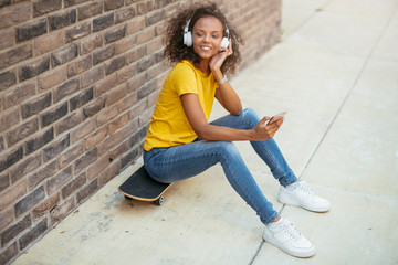 African skater girl using phone © JustLife