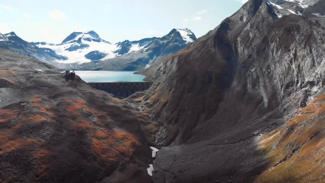 Aerial view of the dam into the mountain formations, Alps formazza valley between Italy and Switzerland border. 4k