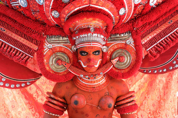 Dancer at a traditional Theyyam ceremony in a temple in Kannur, India. Theyyam is Kerala's most...