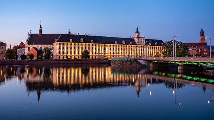 Fototapeta na wymiar View of University of Wroclaw, Odra River and University Bridge in Wroclaw at sunrise. 