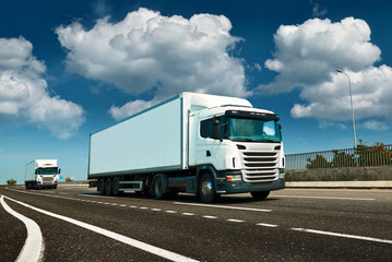 White truck is on highway - business, commercial, cargo transportation concept, clear and blank space on the side view